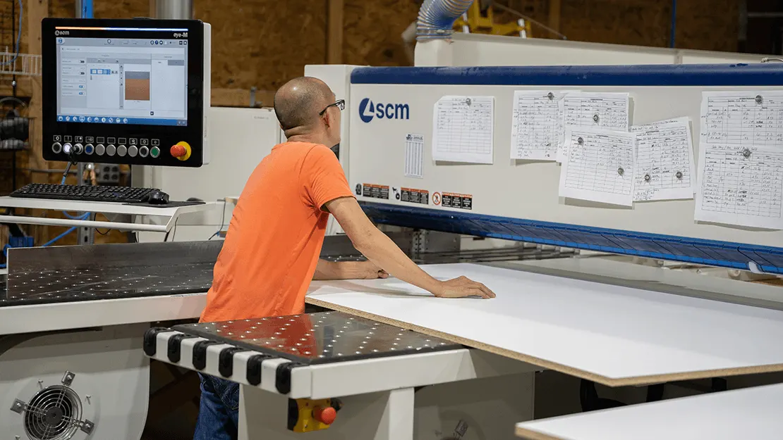 D3 craftsman cutting salon furniture panels on a CNC machine in the USA