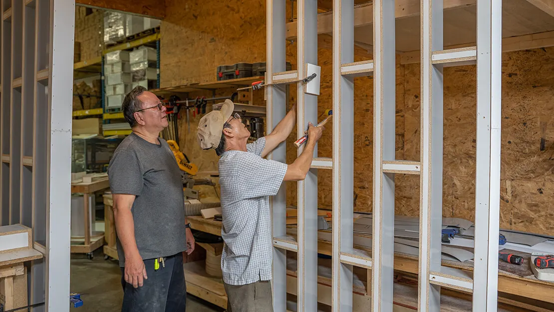 D3 craftsman building salon furniture in the workshop