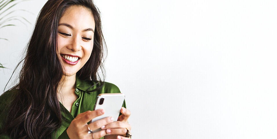 Happy woman texting on a smartphone Happy woman using mobile phone
